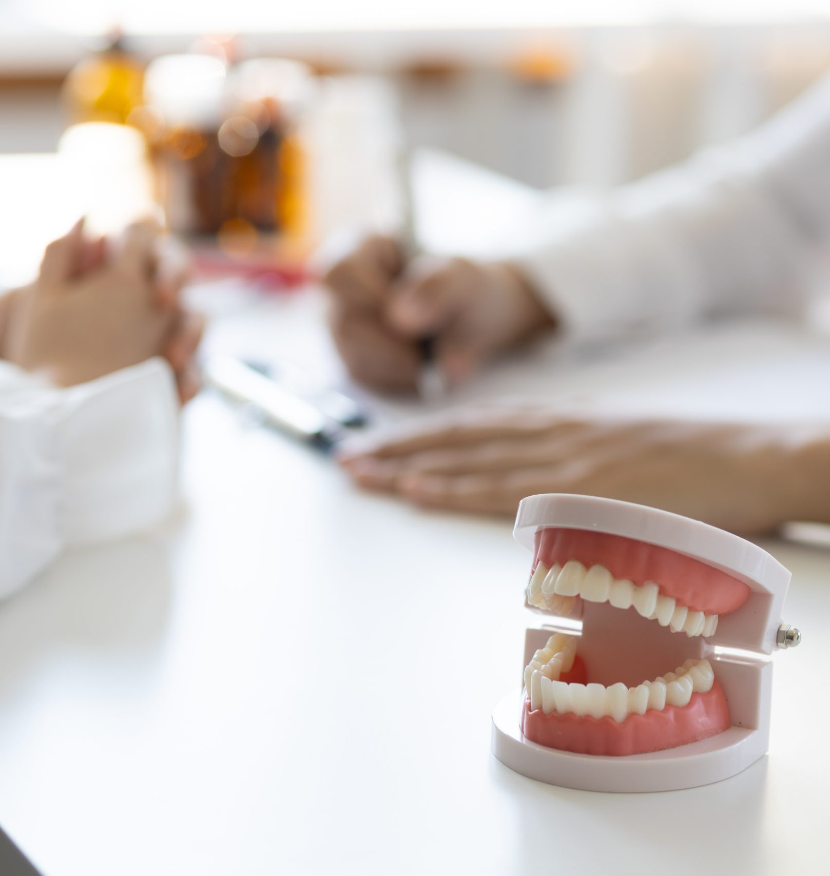 Patient with a toothache sees a dentist in a dental clinic at a hospital examination room. The doctor gives advice on maintaining oral health.